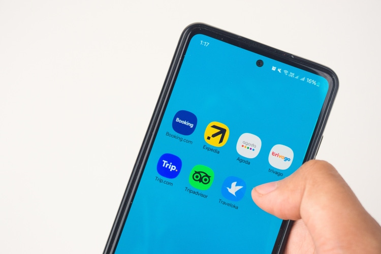 Smartphone Displaying Popular Travel Booking Application Icons on Screen
