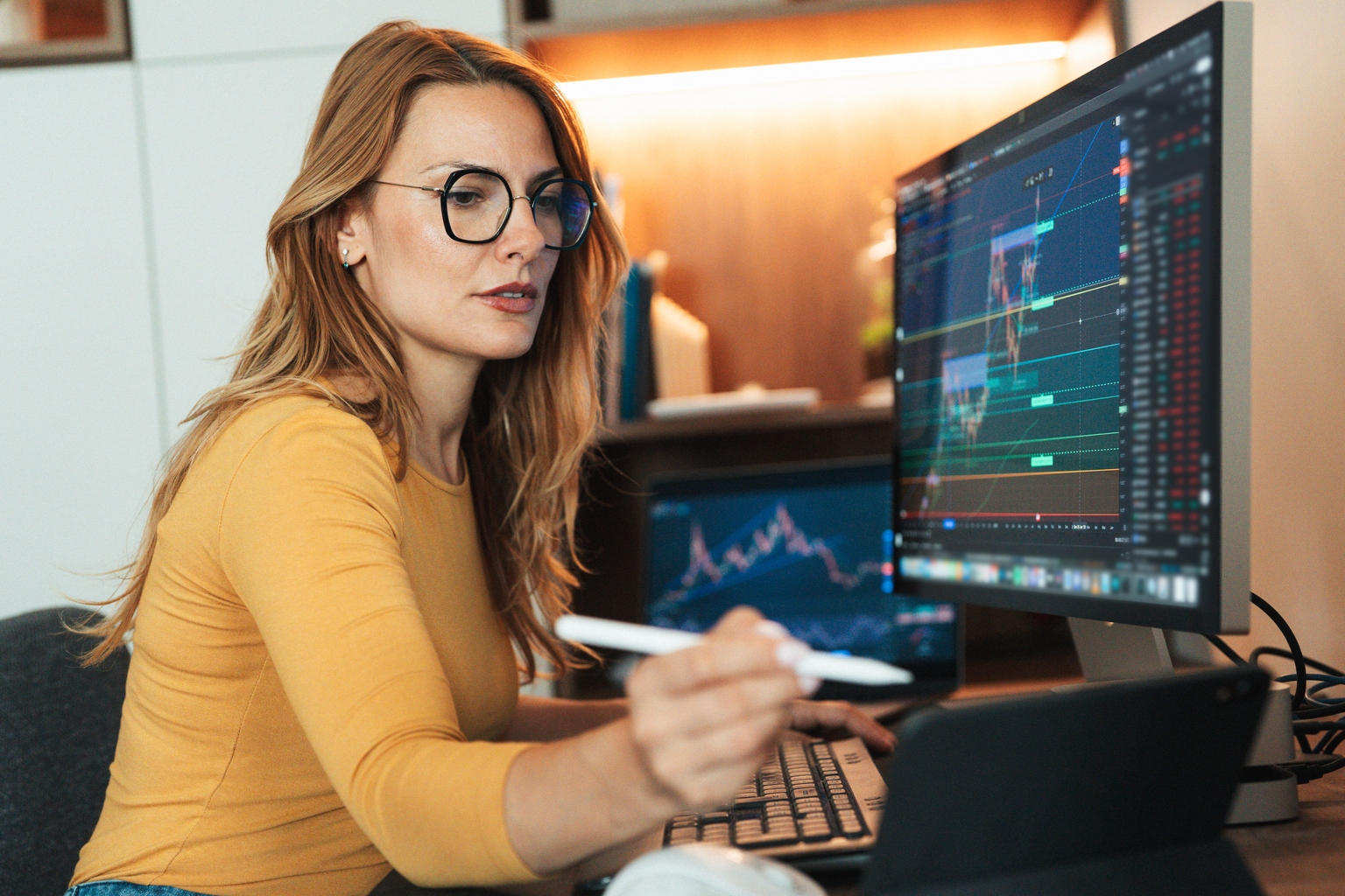 A woman is carefully observing trading crypto charts at home