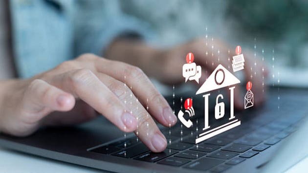 Hands typing on a laptop with banking and alert icons, symbolizing online banking security, digital finance protection, cyber fraud alert, fintech risk management, and financial data safety.