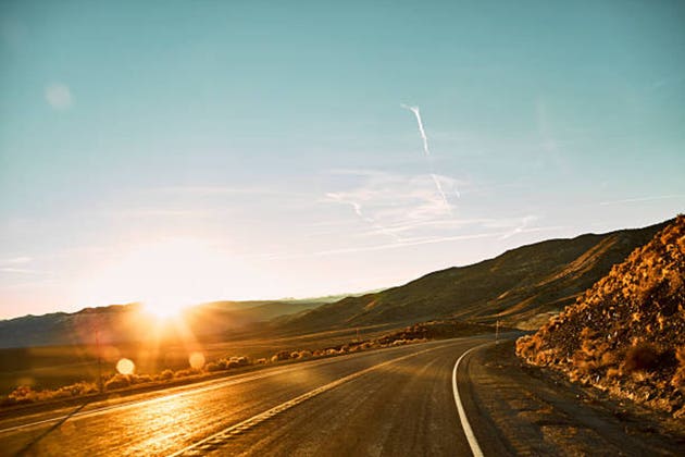 Empty highway in remote location at sunset