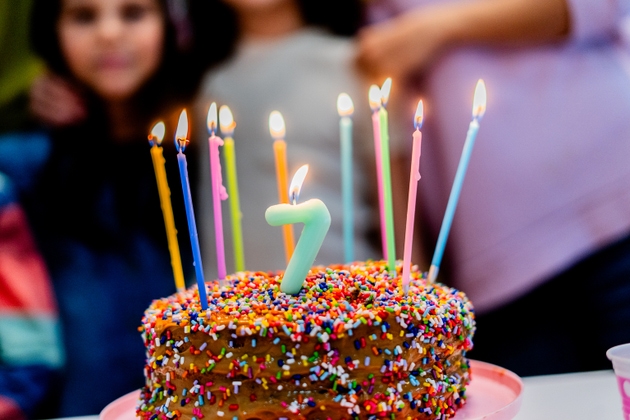 Close-up of a cake with candles during a children"s birthday party