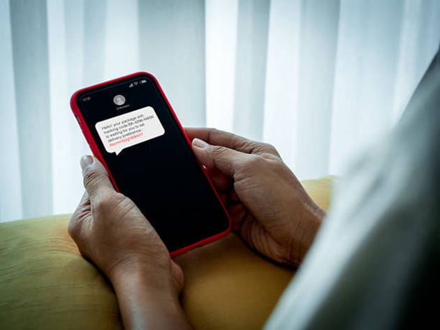 Elderly person receiving suspicious SMS scam on smartphone in hand, concept of fraud message and phishing link, cybercrime, online fraud awareness, digital security and senior lifestyle vulnerability.