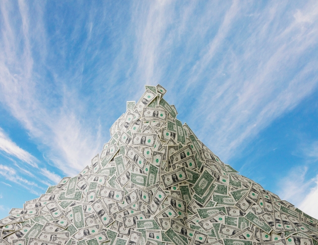 Mountain of cash and blue sky