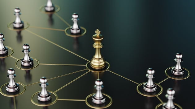 Golden King Surrounded by Silver Pawns Representing Leadership and Strategy