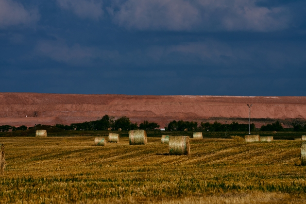 Hay Bales on Farmland with Potash Mine and Freight Train in Saskatchewan