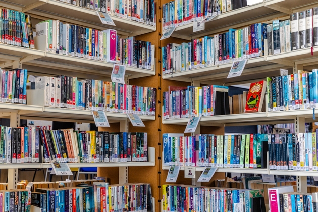 Rows of books in the corner of a high school library, Newcastle upon Tyne, England, United Kingdom