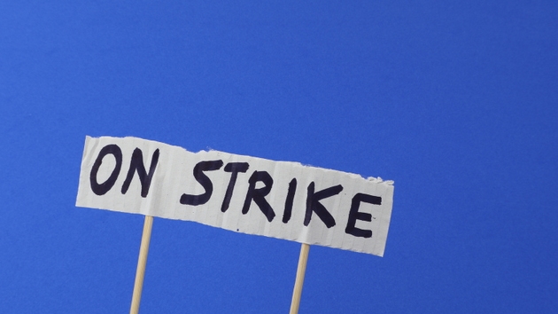 Strike written on a protest sign with a blue background