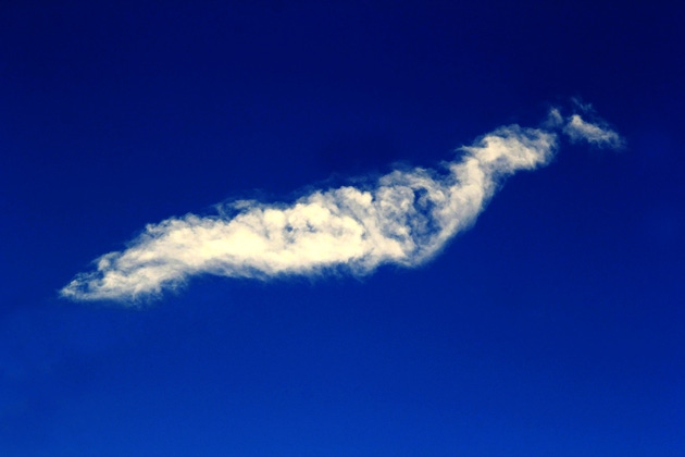 Fluffy white clouds against a vibrant blue sky