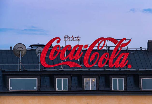 Neon Coca-Cola Sign on Rooftop