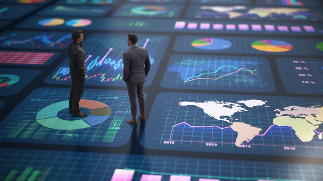 Business professionals analyze data on digital screens in a modern office setting during a meeting focused on performance metrics