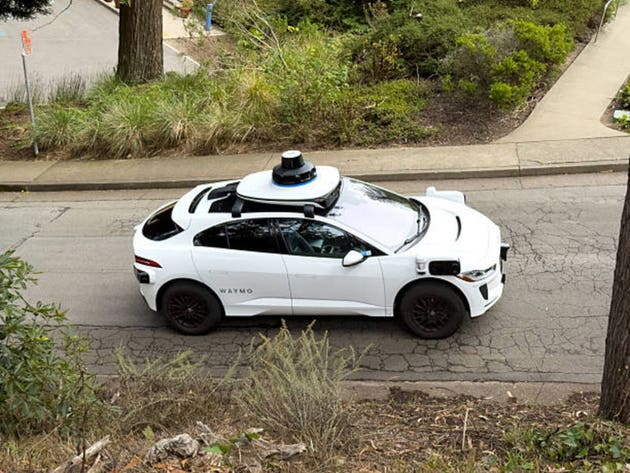 Waymo autonomous Jaguar I-PACE electric self-driving car driving on hilly street