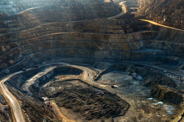 The immense scale of a copper mine in Chile, with roads winding down the massive open pit to the mining area.