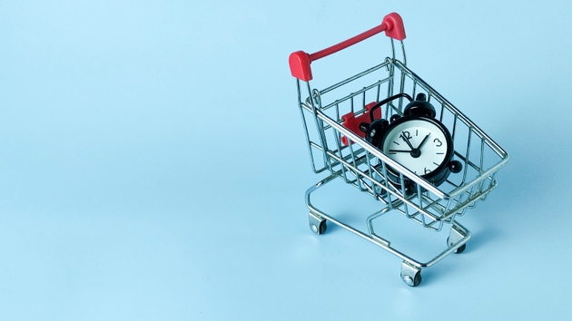 Time-Sensitive E-commerce and Limited Time Offer Concept: Alarm Clock in a Miniature Shopping Cart