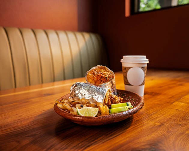 Breakfast burrito with coffee in cozy Mexican restaurant