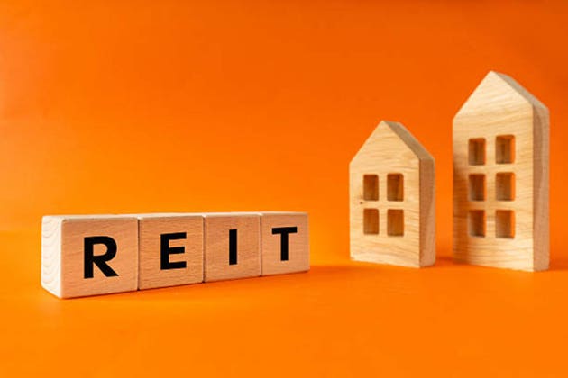 REIT, Real Estate Investment Trust. Business concept. A fund or company that invests in real estate. Real estate portfolio. Buying REIT shares on the stock exchange. Dividends, rental income