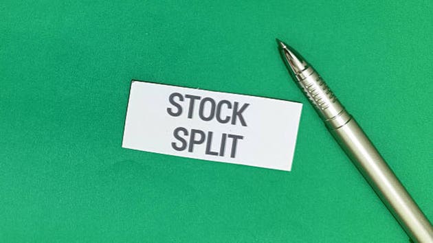 Analyzing stock split impact for investors with pen in green background for financial planning success