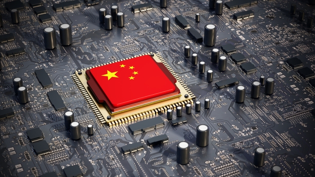 Chinese microchip with the Chinese flag and star symbols is carefully installed on a high-tech mainboard
