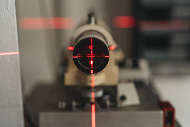 Precision laser sight scope mounted on bedplate during calibration in workshop for optimal targeting efficiency
