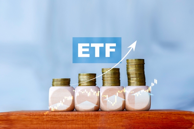 ETF investment growth concept with stacked coins and upward arrow, symbolizing wealth building, stock market, and financial success.