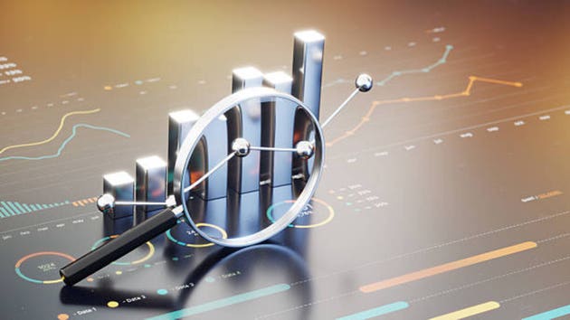 Business Growth Analysis With Magnifying Glass Over Bar Chart And Line Graphs For Data Insights