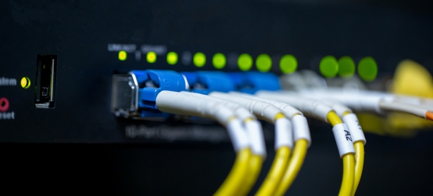 Information technology room computer network ether cable Fiber optic cables and telecommunications net connected to internet switches.
