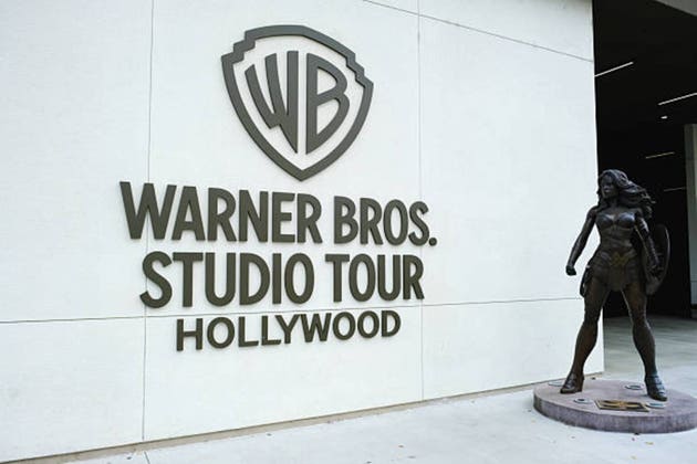 Warner Bros Studio tour entrance sign with Wonder Woman statue.