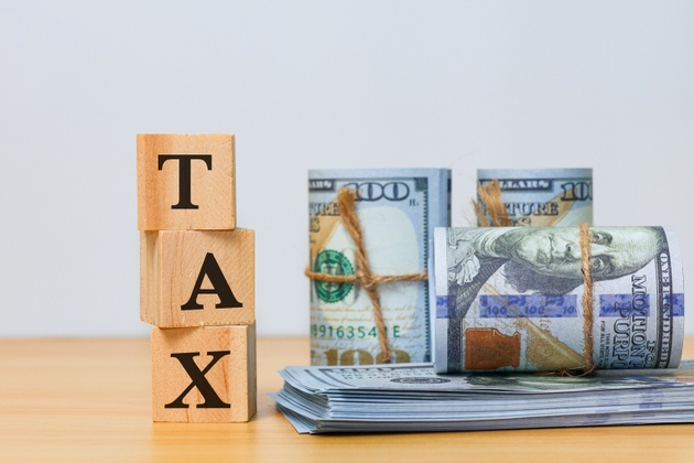 Tax Payment and Financial Responsibility Concept with money and text tax