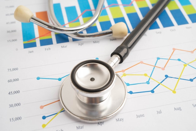 Stethoscope on chart or graph paper, Financial, account, statistics and business data medical health.
