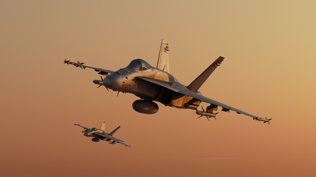 Two tactical twin jet engine fighter aircraft on a combat mission. Modern war jet airplanes flying in formation. Military planes silhuette against sunset. Sound barrier speed, air to air.