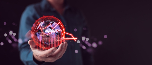 Businessman hand holding virtual world globe with red down arrow graph. Global economic recession concept. Financial crisis, stock market crash, and high inflation business risk background.