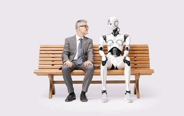 Man and female robot sitting together on a bench
