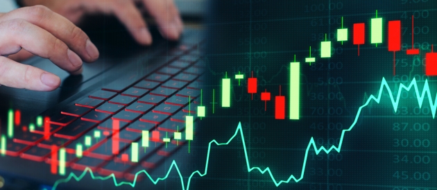Hands using laptop with digital candlestick chart and line graph overlay, concept of online investment and stock market