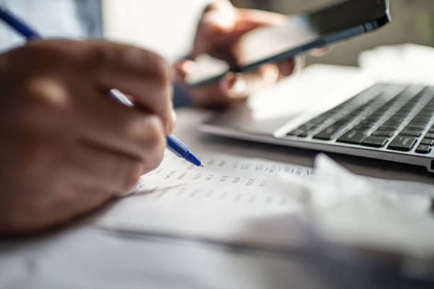 Man with smartphone and financial documents