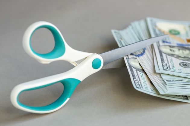 US dollar money. Decrease in the value of the dollar, Increase or decrease in interest rates. Financial and business concept. Cost analysis. Scissors cut banknotes