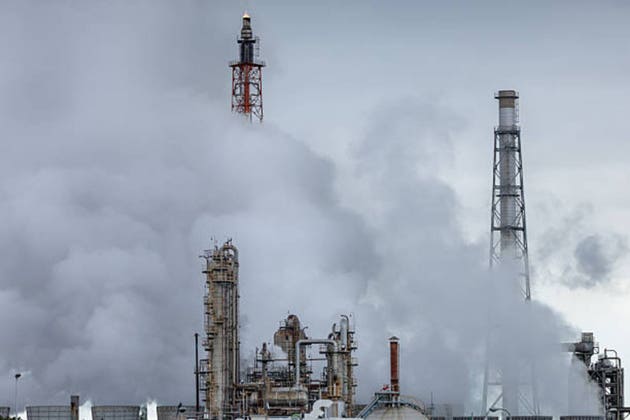 Industrial Refinery Shrouded in Thick Steam and Smoke