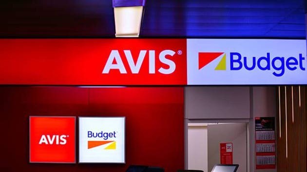 Chopin Airport. Neon sign with the inscription: Avis Budget.