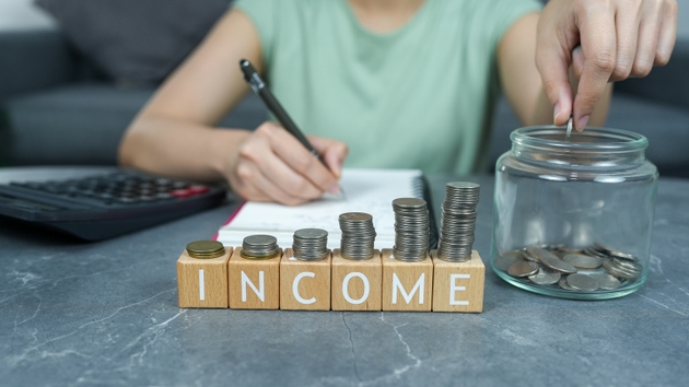 Accounting and Budgeting in Daily Life with Coins, Income, and Financial Planning on a Table