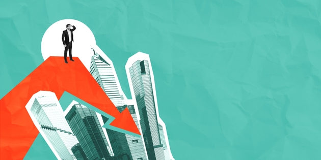 Businessman on red downward arrow over city buildings with teal