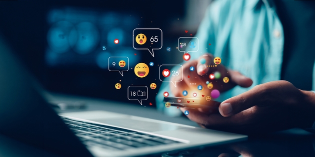 Social media engagement concept with smartphone and floating emoji reactions, likes, and comments, representing digital communication, online interaction, influencer marketing, and modern social networking trends.