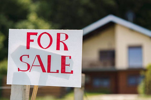 For sale sign marking a suburban house property