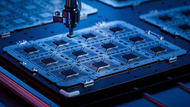 Close-up of Silicon Dies Attached to Substrate on During Computer Chip Manufacturing at a Fab. Microchip Production and Packaging Process at a Semiconductor Factory.