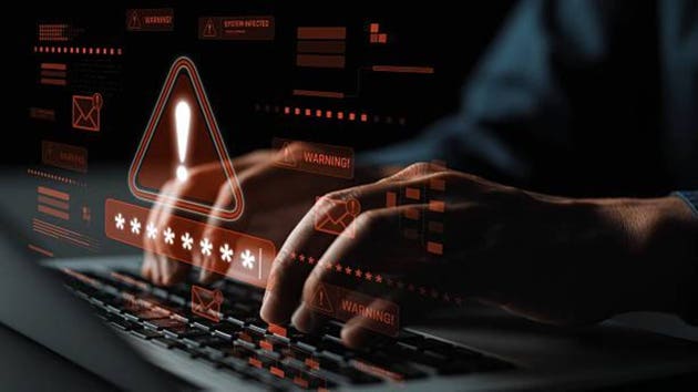 Close-up of Hands Typing on a Laptop with Security Warning Overlay and Data Protection Concept for Cybersecurity and Technology Themes