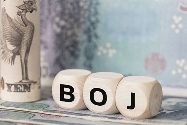 Bank of Japan acronym. Wooden blocks spelling BOJ and Japanese Yen banknotes. Japan monetary policy, central bank economy, macroeconomic indicators and Tokyo financial market business background.