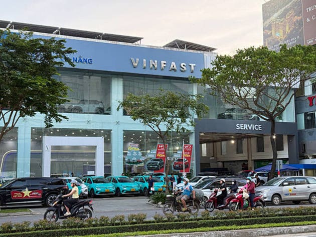 VinFast Dealership Exterior with Electric Taxis on City Street