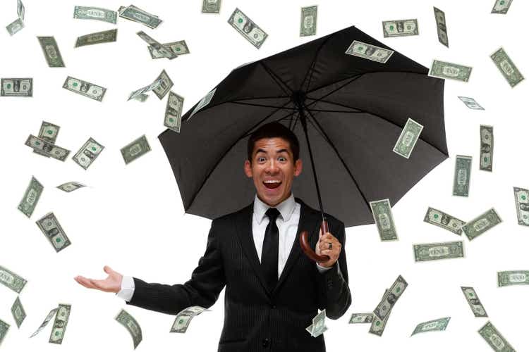 Excited businessman raining money