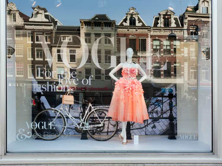 Vogue Fashion display window with reflection of old Amsterdam houses