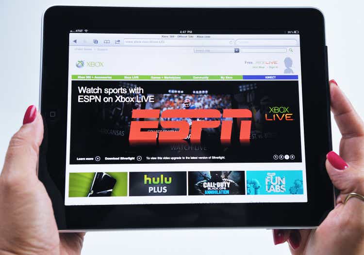 Woman with iPad showing ESPN Xbox video game