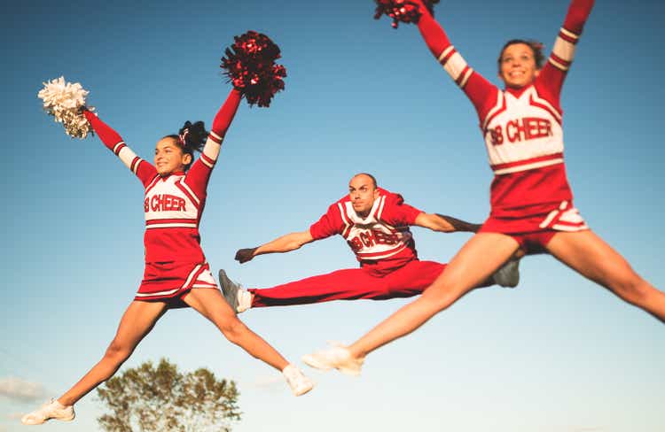 cheerleaders jumping team with pon-pon