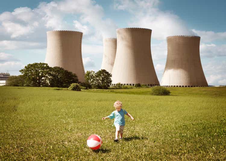 Little boy playing close to the nuclear plant
