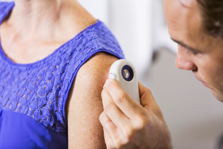 Dermatologist examining patient